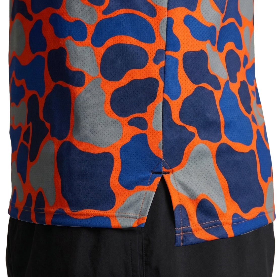 Men's Vapor Lite Racing Singlet in Urban Camo Orange featuring a bold camouflage pattern in bright orange, royal blue, and gray on a lightweight mesh fabric with a side slit hem detail.