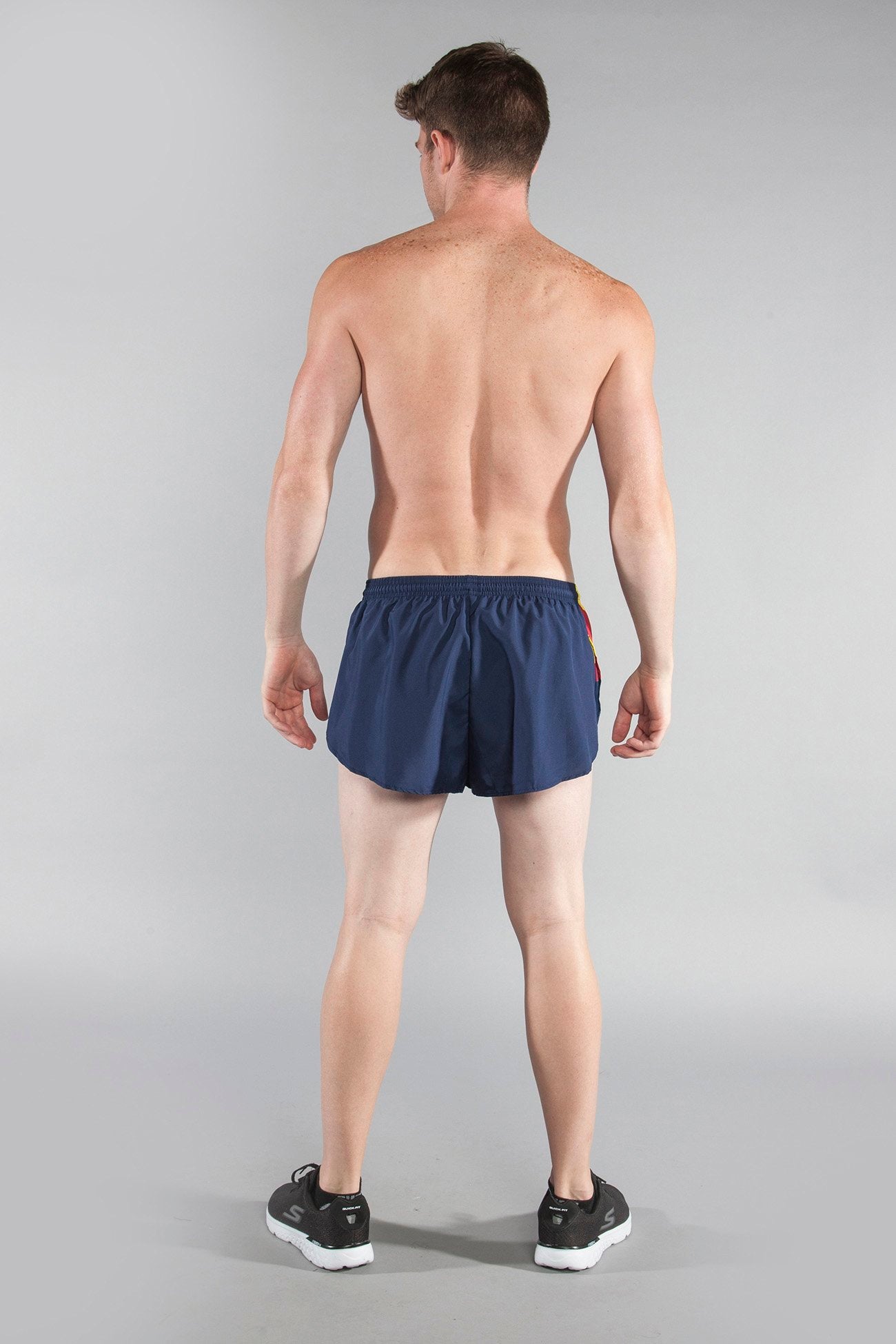 Men's Flag 1" Elite Split Shorts Arizona in navy blue with colorful side stripe detail, shown from the back on a male model wearing black sneakers.