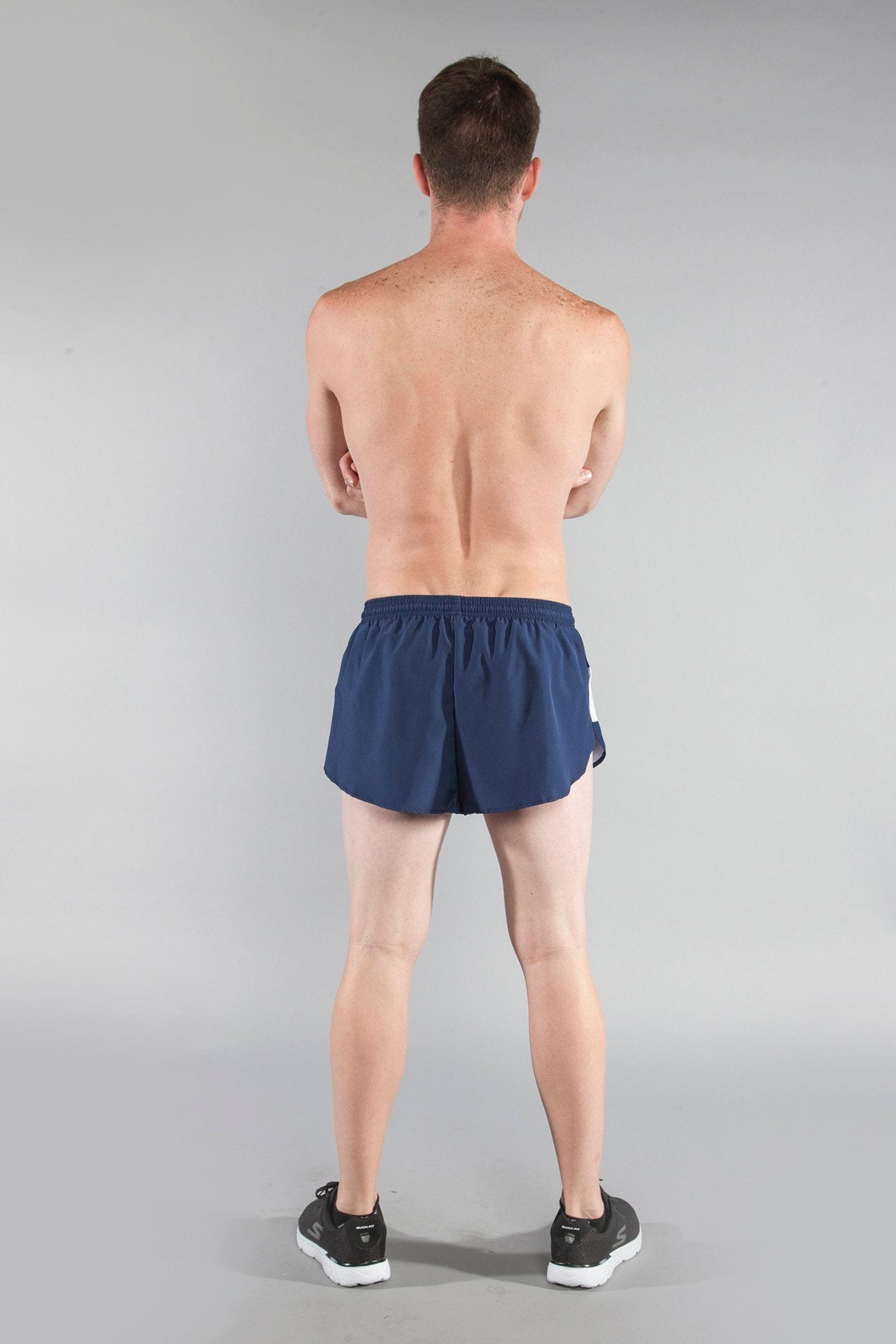 Men's Flag 1" Elite Split Shorts in navy blue with white side panel detail, shown from the back on a male model wearing black Skechers sneakers — Colorado edition.